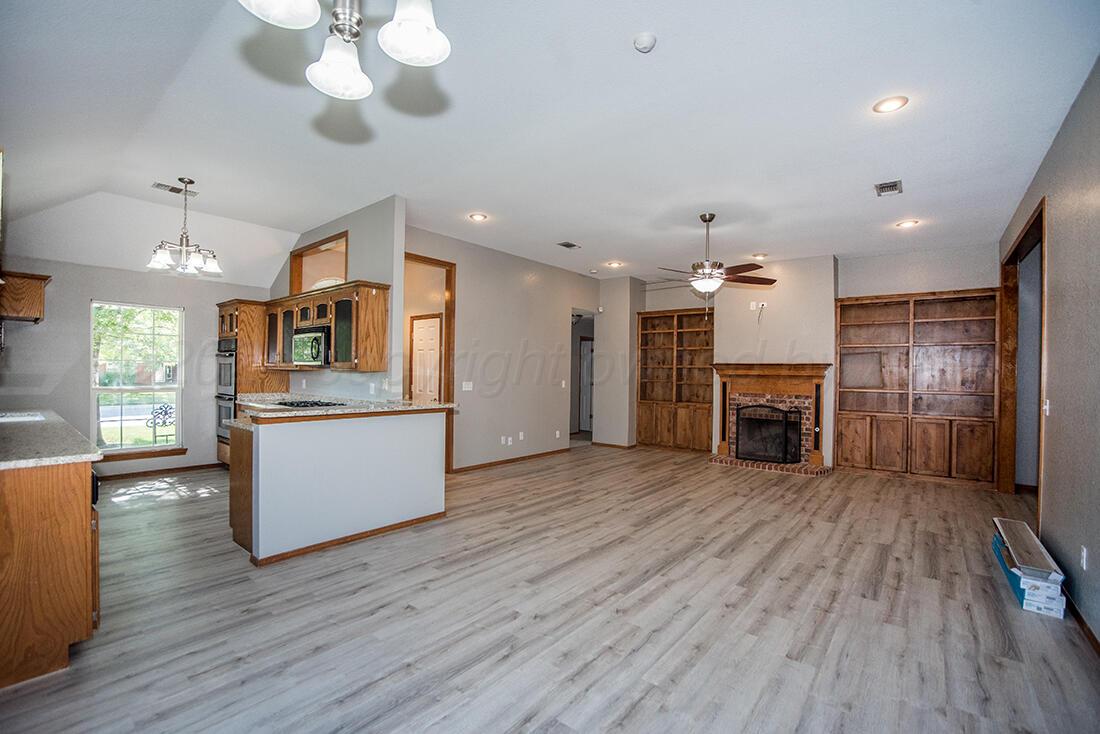 7909 Triumph Place Amarillo, TX 79119 - Photo 6 of 21 a large kitchen with cabinets wooden floor and stainless steel appliances