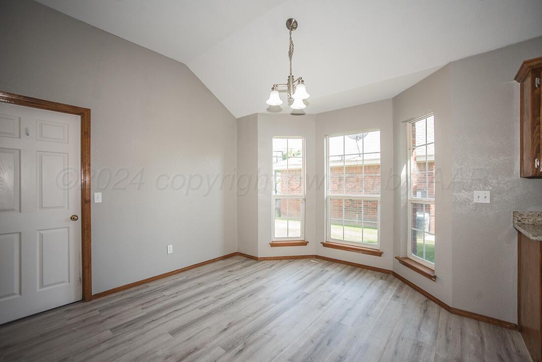 7909 Triumph Place Amarillo, TX 79119 - Photo 7 of 21 a view of livingroom with hardwood floor and window