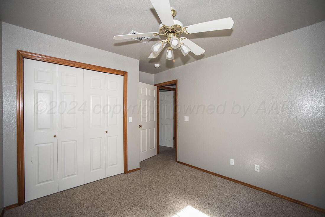 7909 Triumph Place Amarillo, TX 79119 - Photo 10 of 21 a view of an empty room and chandelier fan