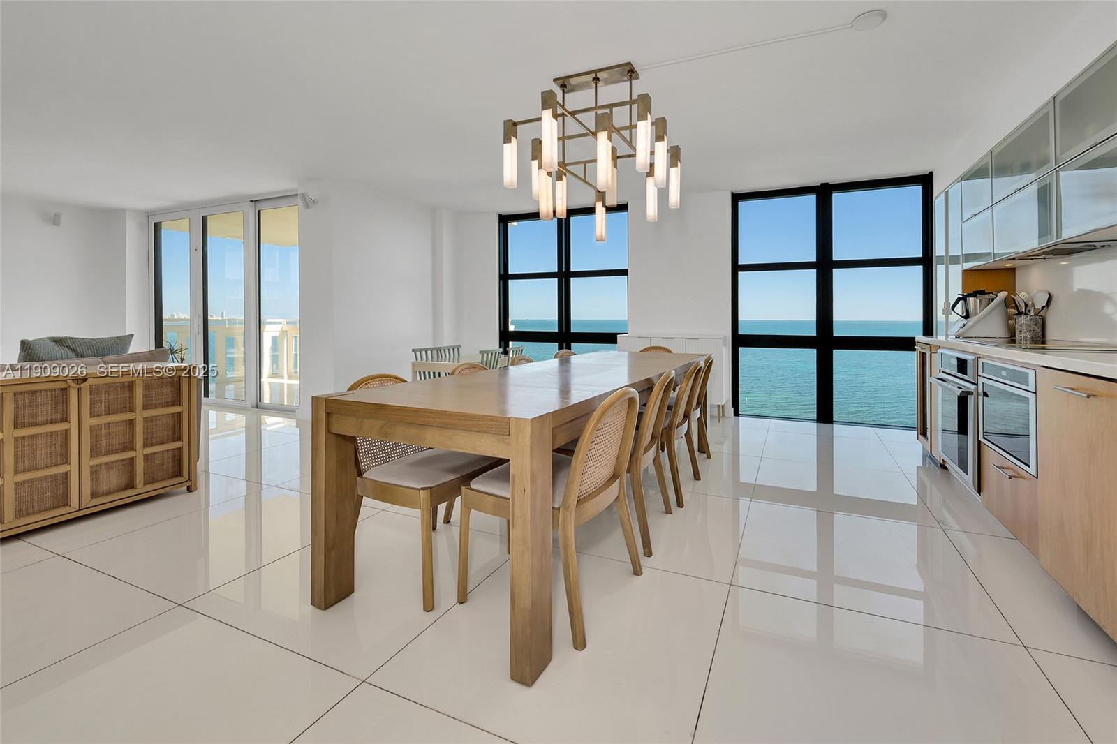 1111 Crandon Boulevard, Unit A801 Key Biscayne, FL 33149 - Photo 12 of 29 a dining area with a table chairs and a kitchen view