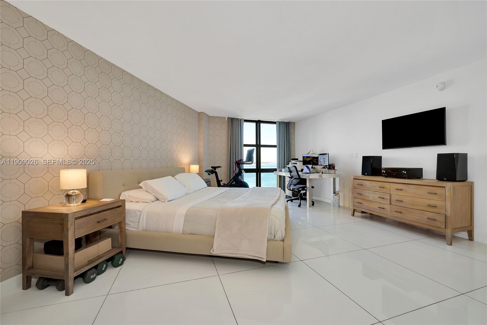 1111 Crandon Boulevard, Unit A801 Key Biscayne, FL 33149 - Photo 18 of 29 a bedroom with a bed and a flat screen tv