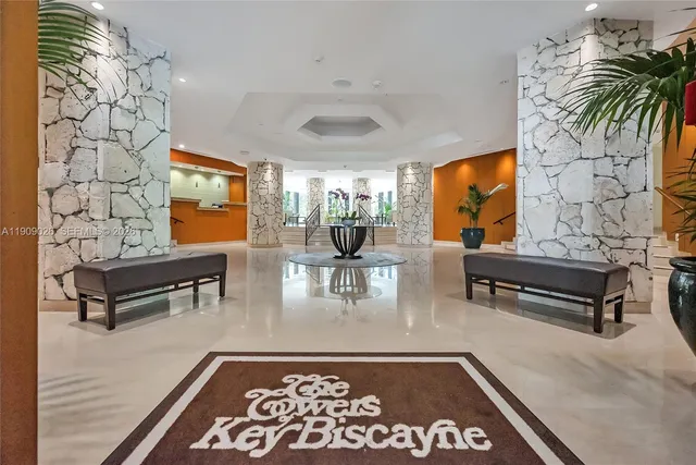 a living room with furniture a flat screen tv and a floor to ceiling window