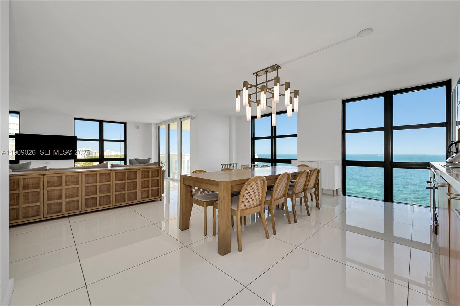 1111 Crandon Boulevard, Unit A801 Key Biscayne, FL 33149 - Photo 10 of 29 a dining room with furniture and chandelier