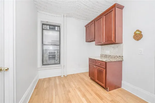 a kitchen with granite countertop a sink stove and cabinets