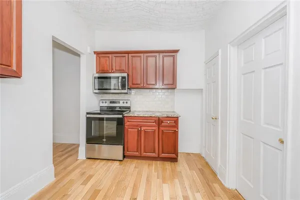 a kitchen with stainless steel appliances granite countertop a stove a sink and a refrigerator