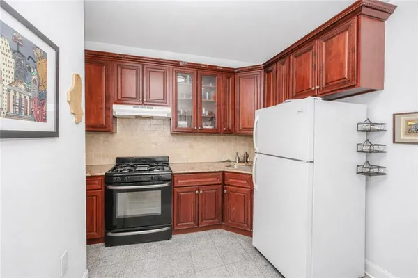 a kitchen with a stove a refrigerator and a sink