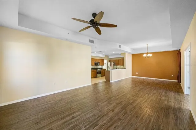 a view of empty room with wooden floor and window