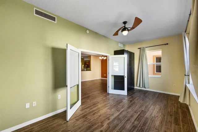 a view of empty room with wooden floor