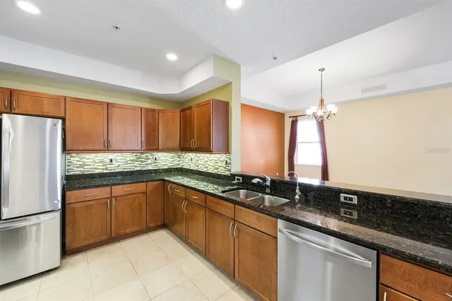a kitchen with stainless steel appliances granite countertop a sink and cabinets