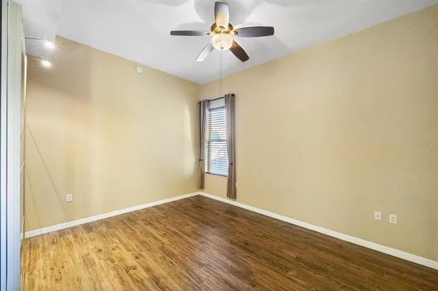 a view of empty room with wooden floor