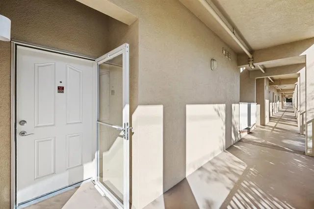 a view of a hallway with wooden floor and entryway