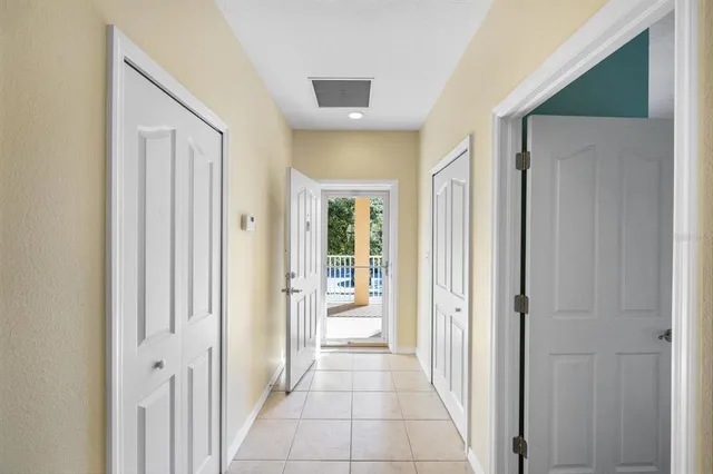 a view of a hallway with wooden shelves