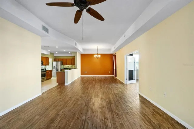 a view of a room with wooden floor and windows
