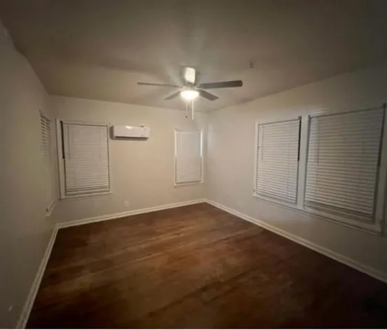 a view of an empty room with a ceiling fan