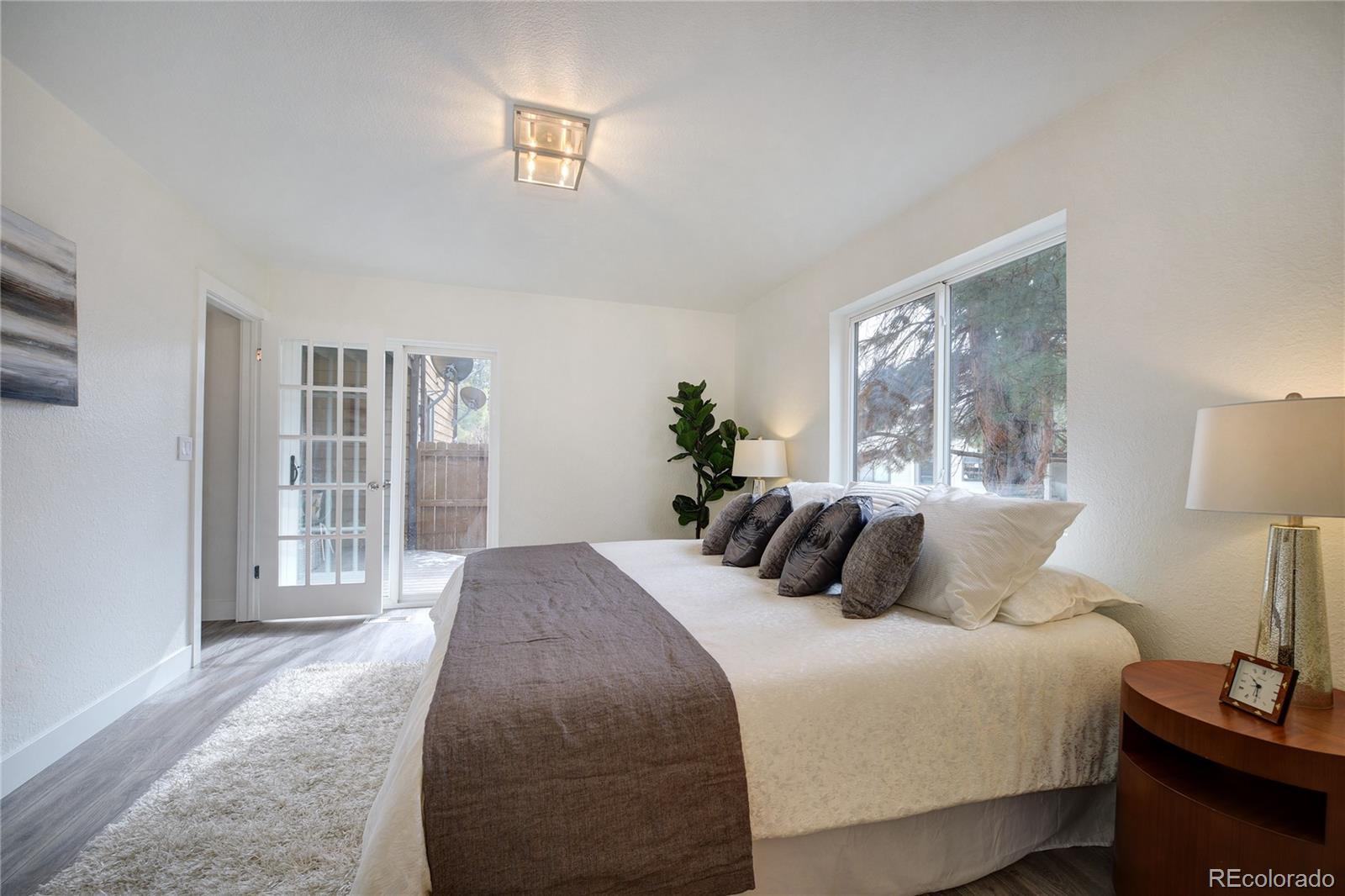 6240 Willow Lane Boulder, CO 80301 - Photo 13 of 25 a bedroom with a bed and a night stand