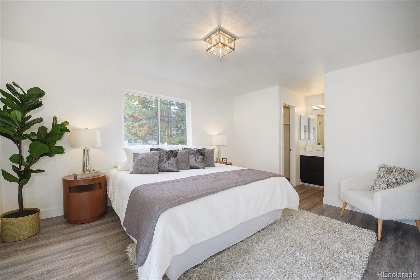 6240 Willow Lane Boulder, CO 80301 - Photo 15 of 25 a bedroom with a large bed and a potted plant