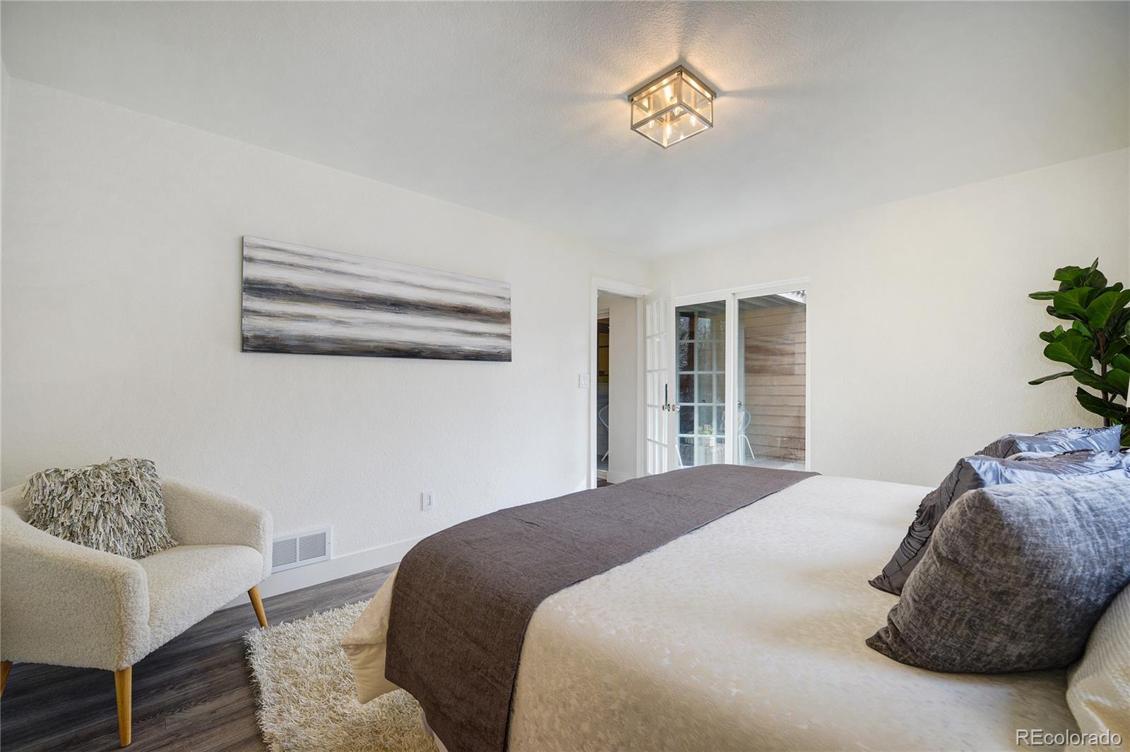 6240 Willow Lane Boulder, CO 80301 - Photo 18 of 25 a bedroom with a bed and a chair