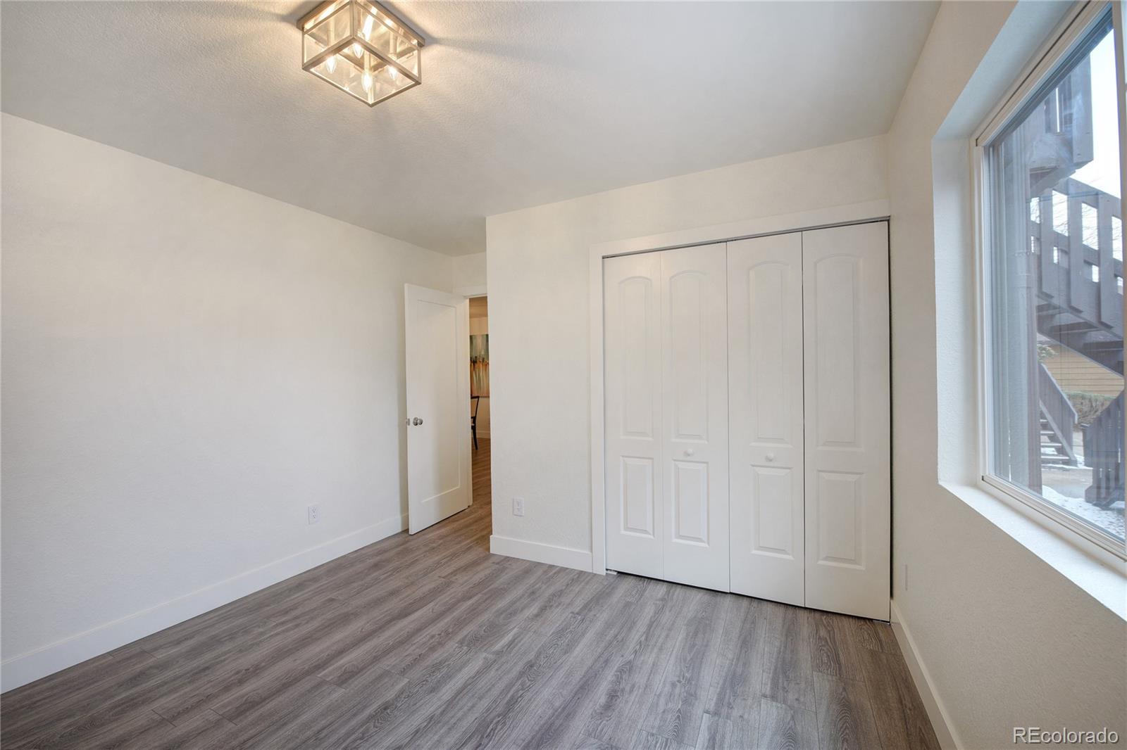 6240 Willow Lane Boulder, CO 80301 - Photo 20 of 25 a view of an empty room with wooden floor and a window
