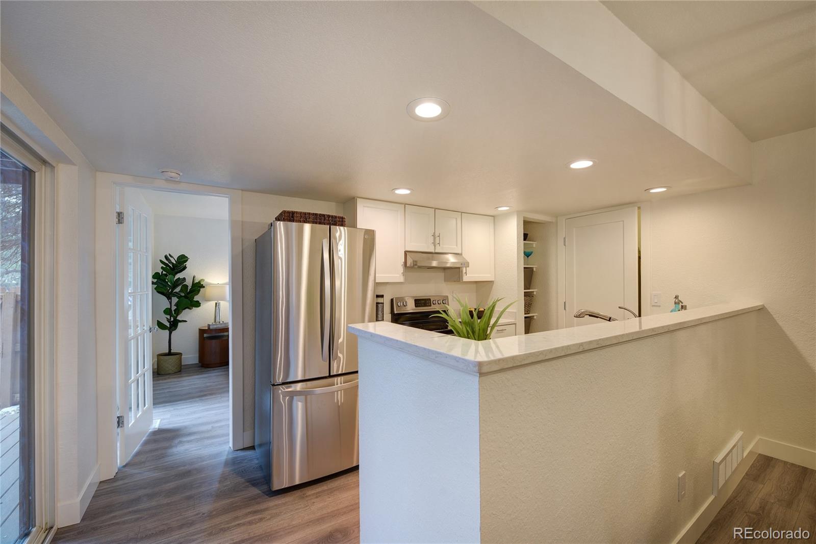 6240 Willow Lane Boulder, CO 80301 - Photo 5 of 25 a kitchen with stainless steel appliances a refrigerator sink and wooden floor