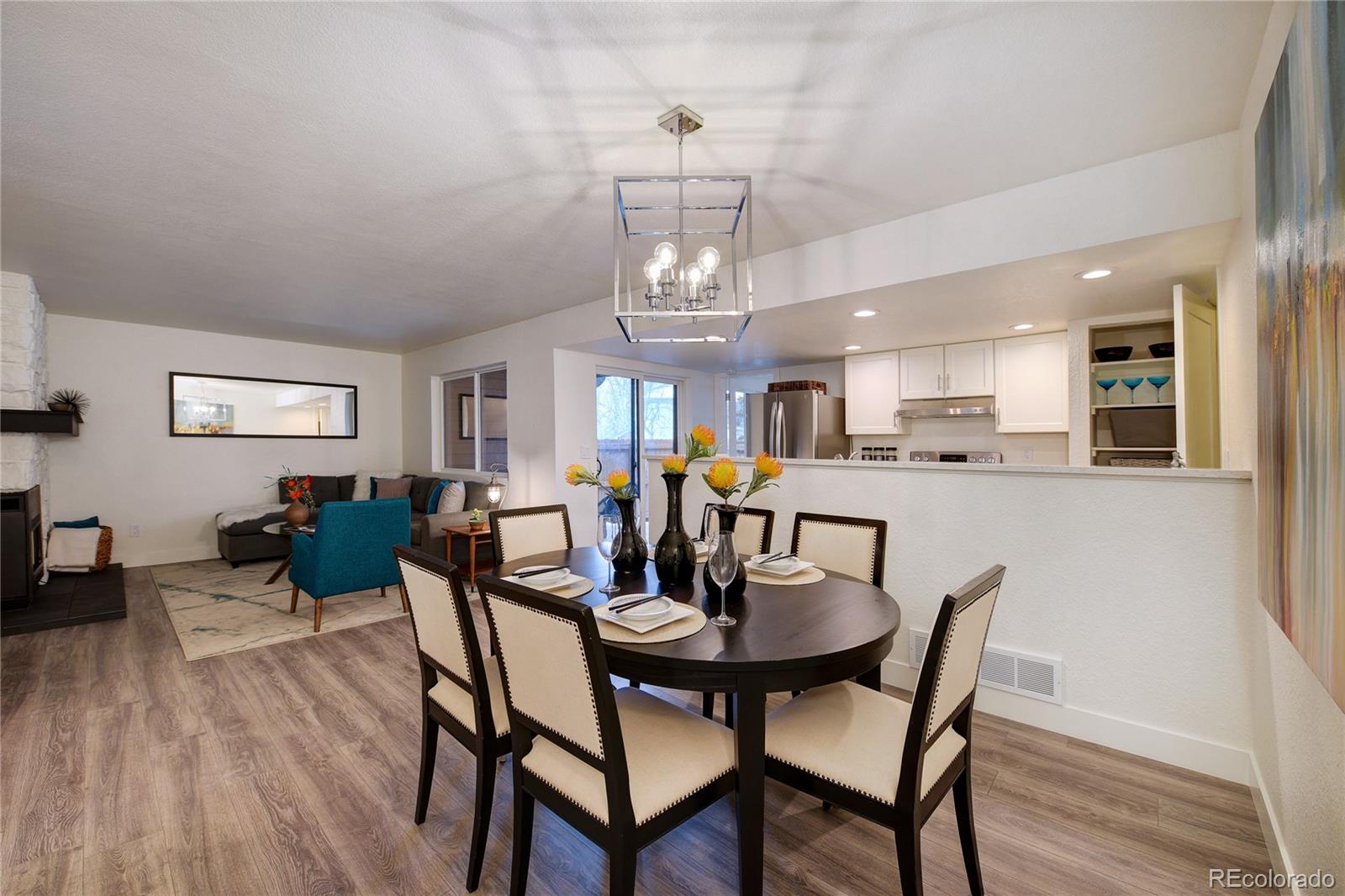 6240 Willow Lane Boulder, CO 80301 - Photo 6 of 25 a view of a dining room with furniture a chandelier and wooden floor