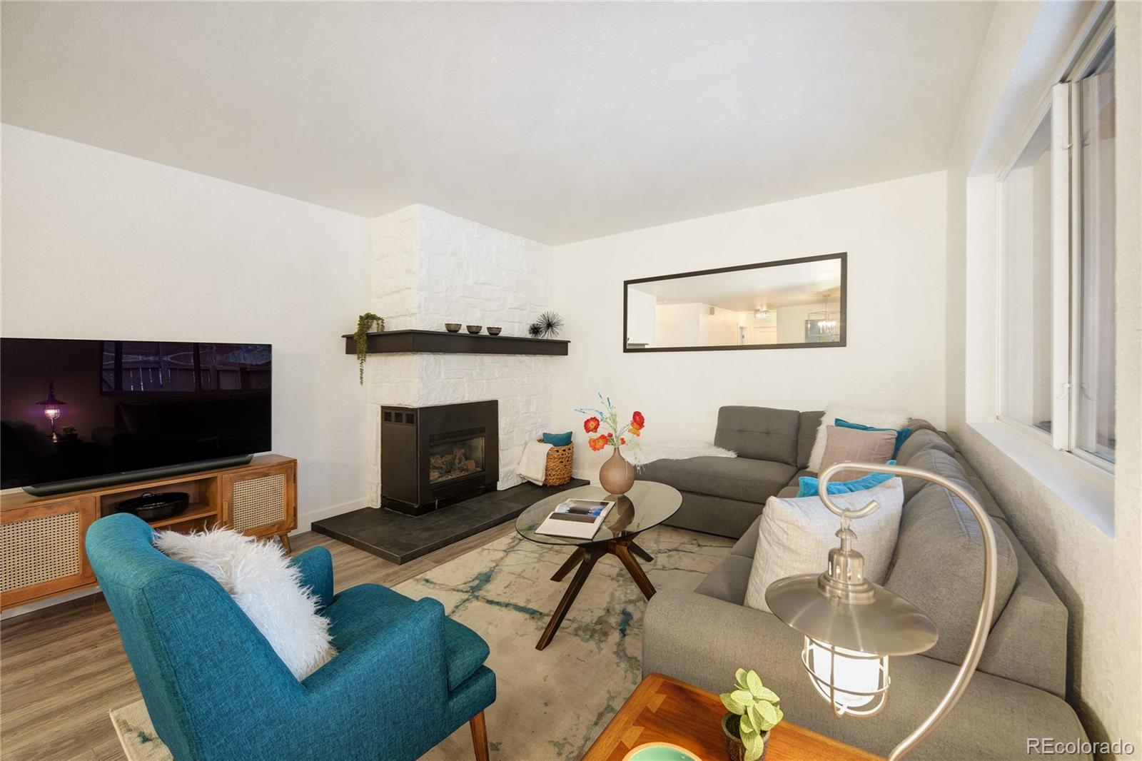 6240 Willow Lane Boulder, CO 80301 - Photo 9 of 25 a living room with furniture a fireplace and a flat screen tv