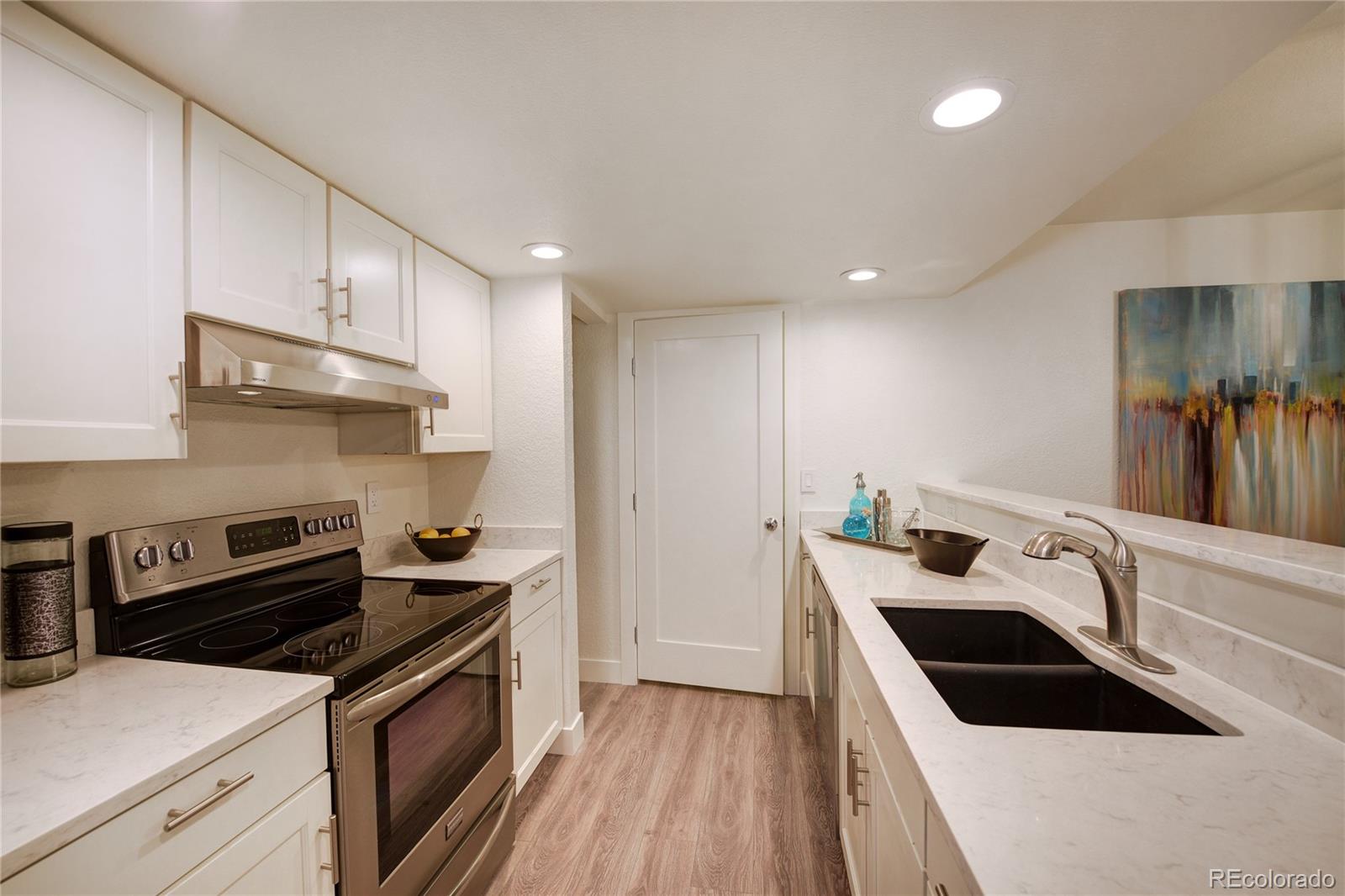 6240 Willow Lane Boulder, CO 80301 - Photo 10 of 25 a kitchen with a sink a stove and cabinets
