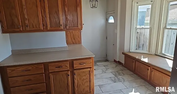 a kitchen with granite countertop wooden cabinets