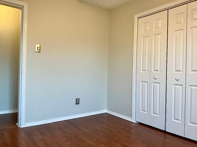 an empty room with wooden floor