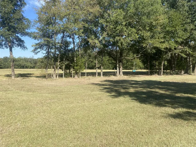 a view of a water fountain and trees