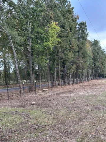 a backyard of a house with lots of trees