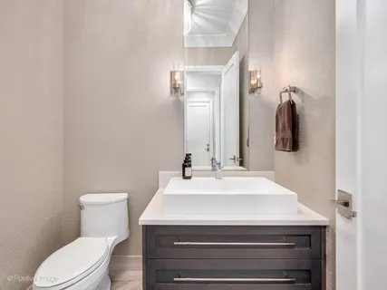 a spacious bathroom with a bathtub sink and mirror