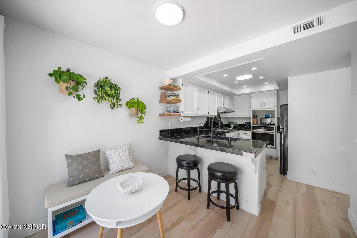 1496 Oakridge Park Road Santa Maria, CA 93455 - Photo 18 of 62 a kitchen with a table and chairs in it