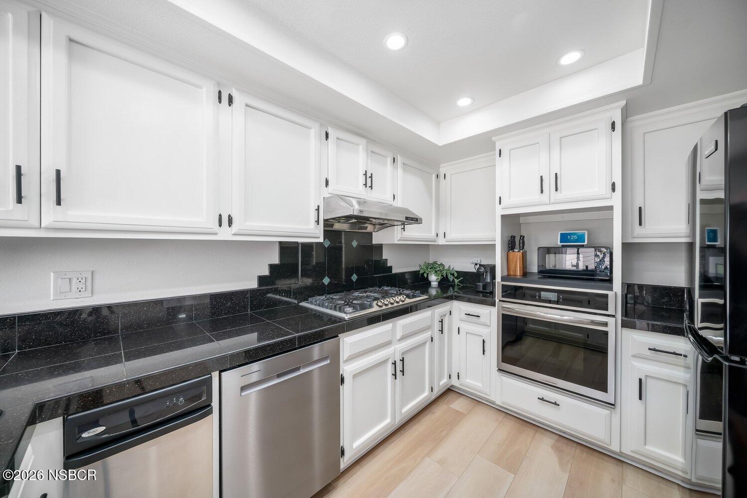 1496 Oakridge Park Road Santa Maria, CA 93455 - Photo 19 of 62 a kitchen with stainless steel appliances granite countertop a stove and cabinets