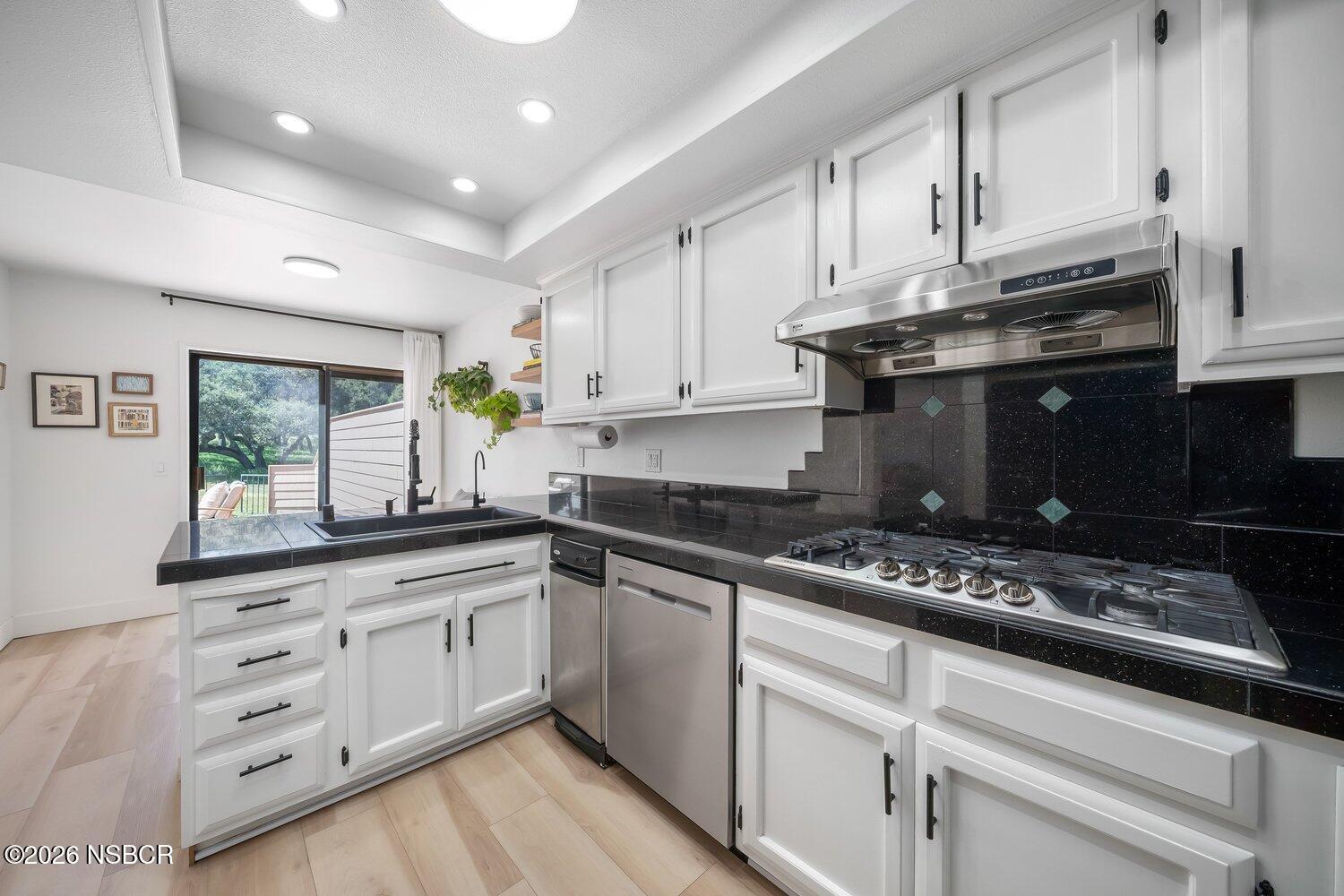 1496 Oakridge Park Road Santa Maria, CA 93455 - Photo 22 of 62 a kitchen with granite countertop a sink cabinets stainless steel appliances and a window