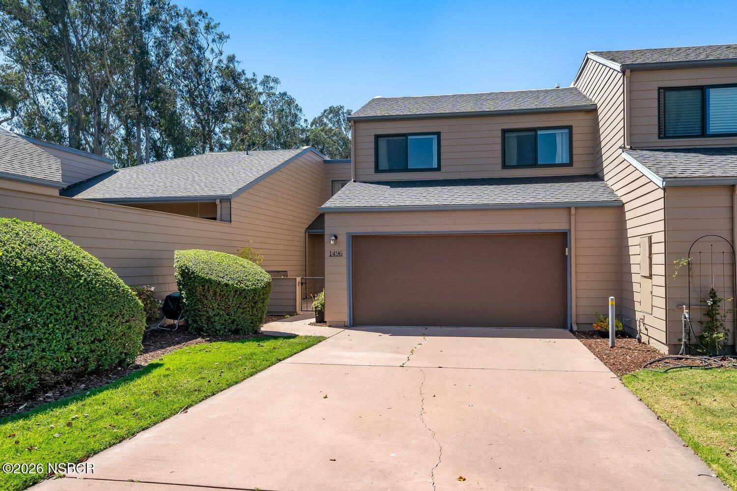 1496 Oakridge Park Road Santa Maria, CA 93455 - Photo 41 of 62 a front view of a house with a yard and garage