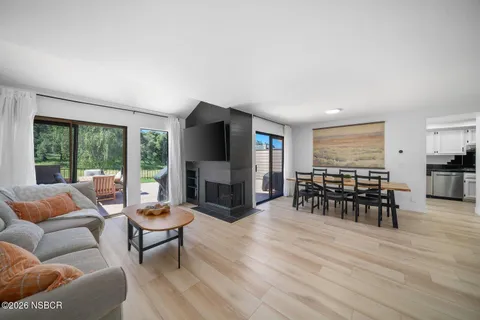 a view of a dining room with furniture window and wooden floor