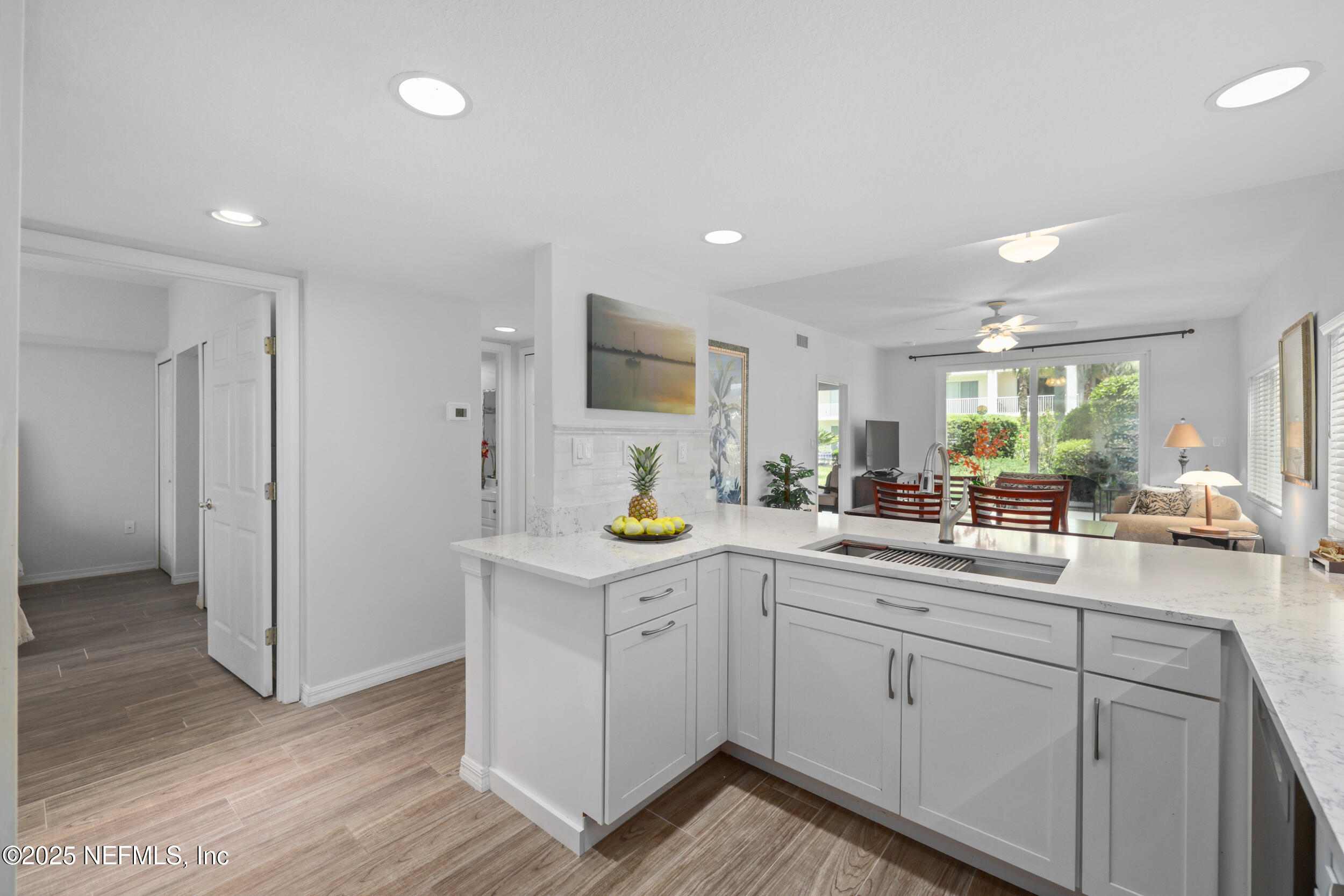 159 Marine Street, Unit 105 St. Augustine, FL 32084 - Photo 11 of 46 a kitchen with sink cabinets and wooden floor