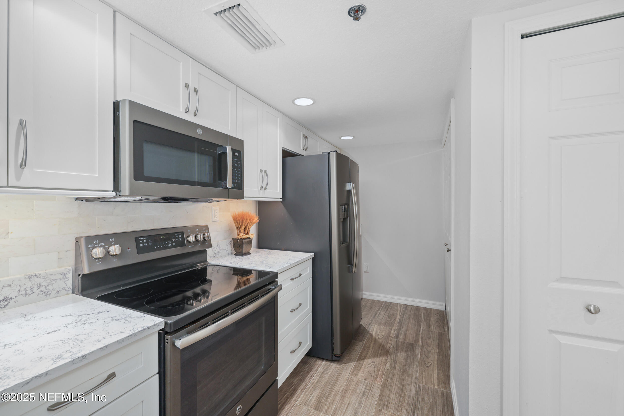159 Marine Street, Unit 105 St. Augustine, FL 32084 - Photo 12 of 46 a kitchen with a stove microwave and refrigerator