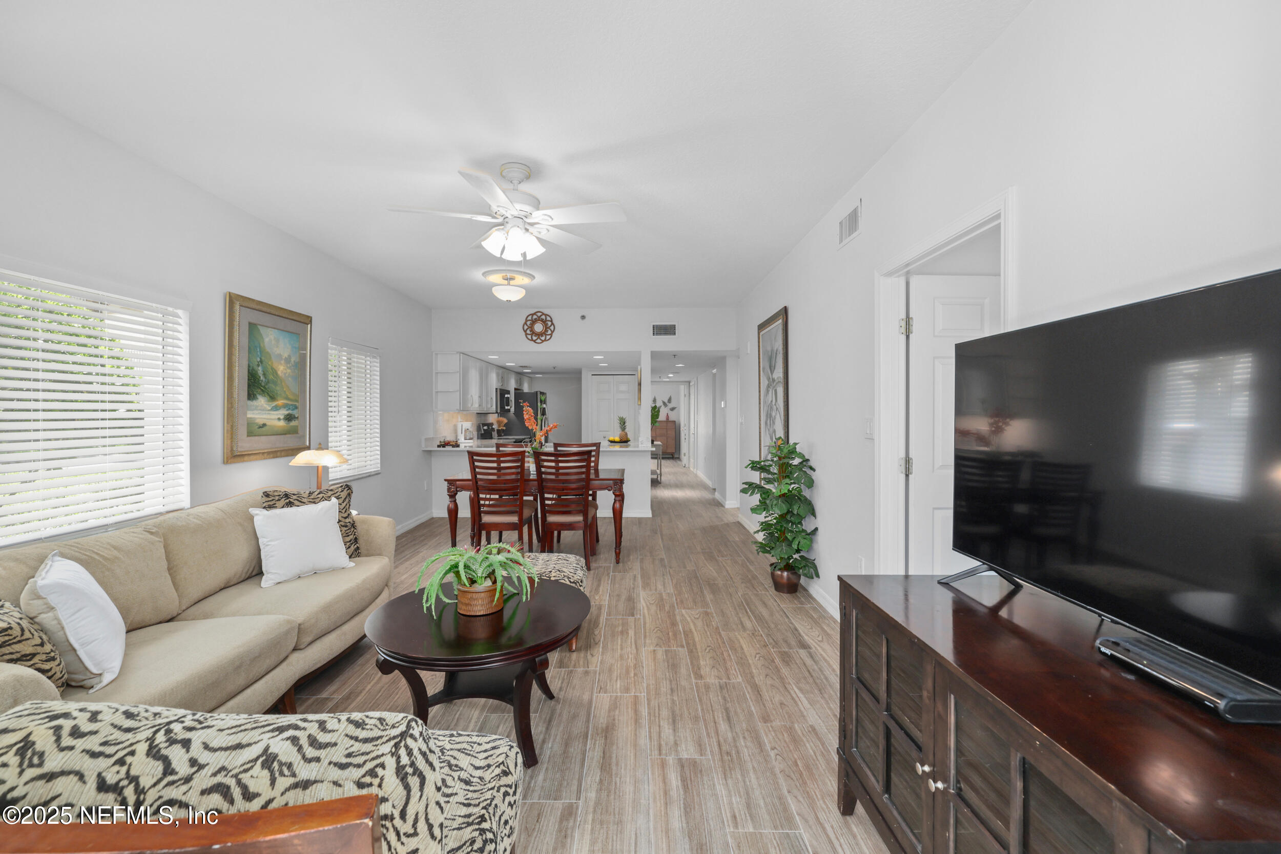 159 Marine Street, Unit 105 St. Augustine, FL 32084 - Photo 18 of 46 a living room with furniture and a flat screen tv