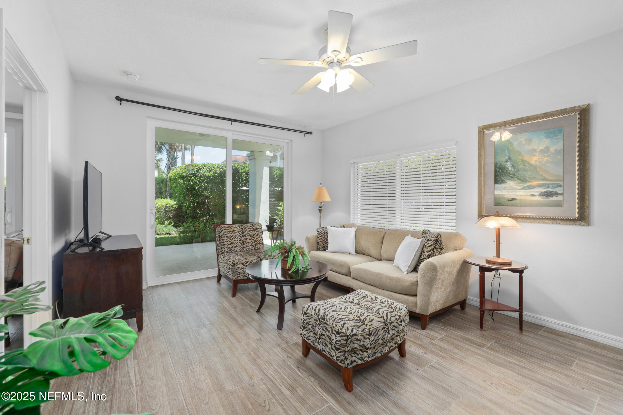 159 Marine Street, Unit 105 St. Augustine, FL 32084 - Photo 19 of 46 a living room with furniture flat screen tv and a large window