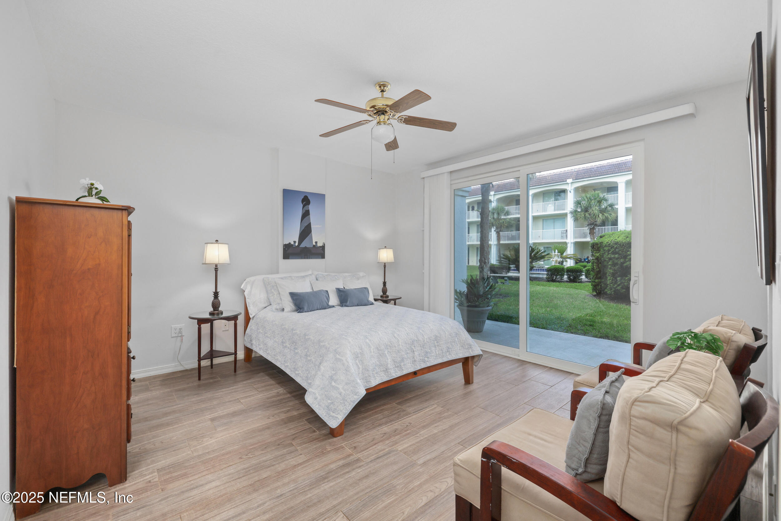 159 Marine Street, Unit 105 St. Augustine, FL 32084 - Photo 20 of 46 a bedroom with a bed and wooden floor