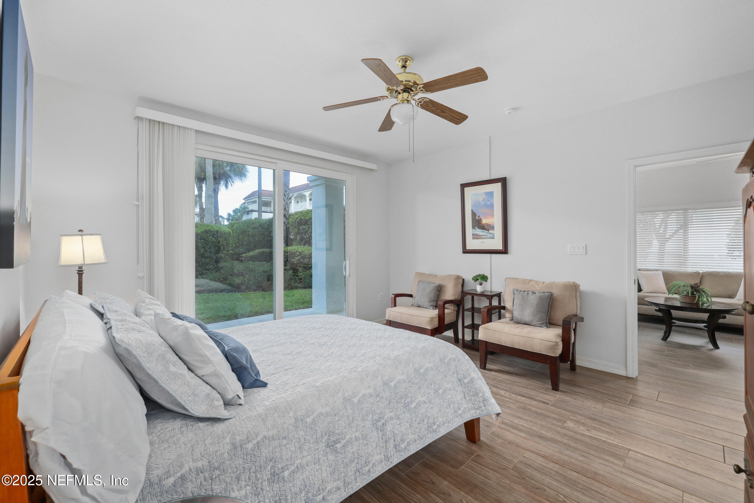 159 Marine Street, Unit 105 St. Augustine, FL 32084 - Photo 21 of 46 a bedroom with a bed and wooden floor