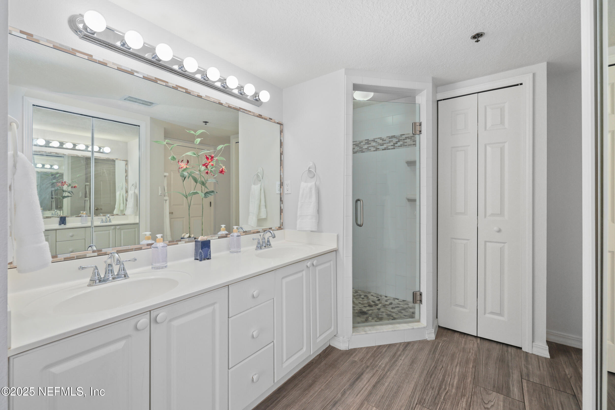 159 Marine Street, Unit 105 St. Augustine, FL 32084 - Photo 23 of 46 a bathroom with a double vanity sink and a mirror