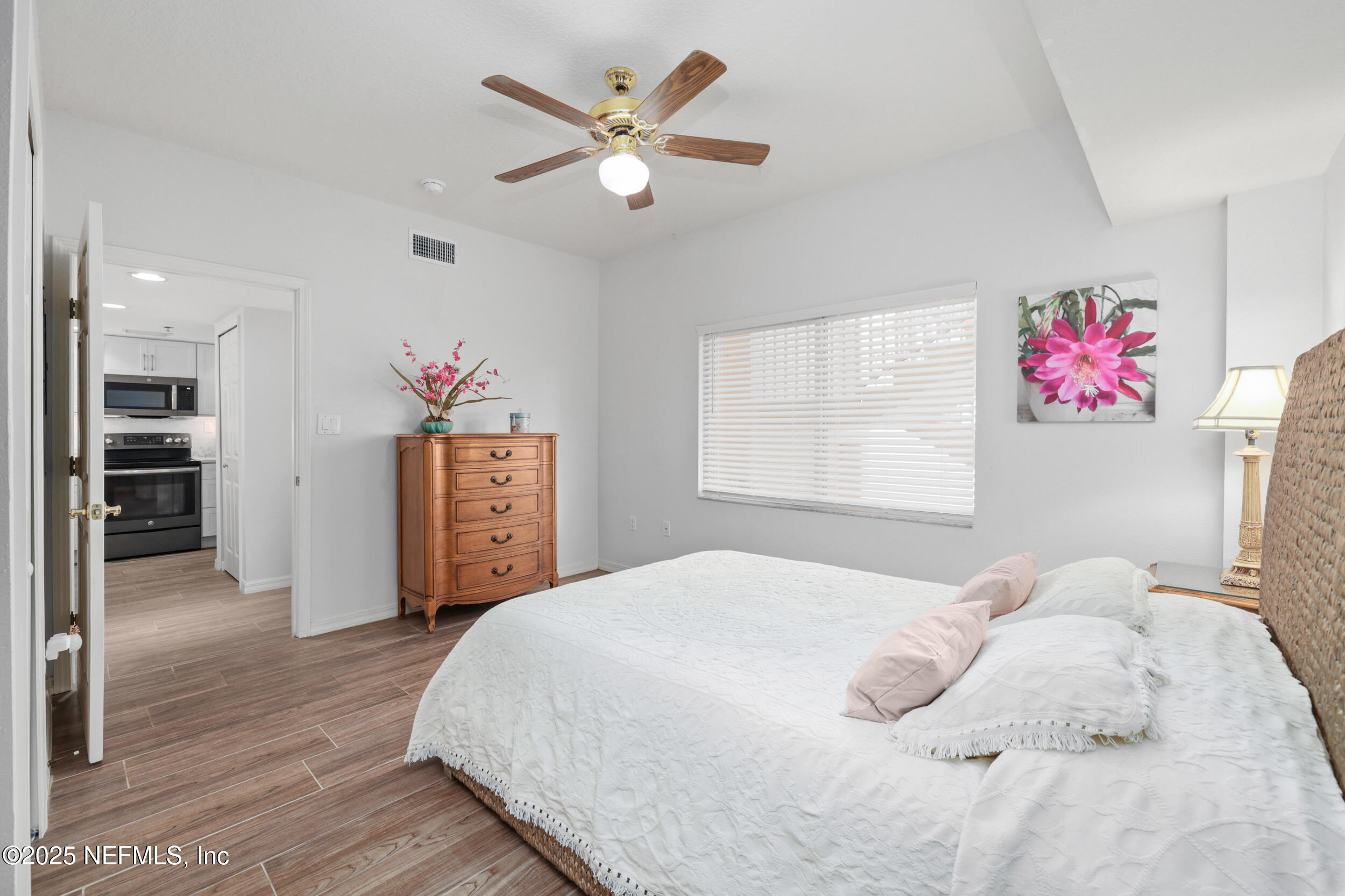 159 Marine Street, Unit 105 St. Augustine, FL 32084 - Photo 26 of 46 a bedroom with a bed and a chandelier