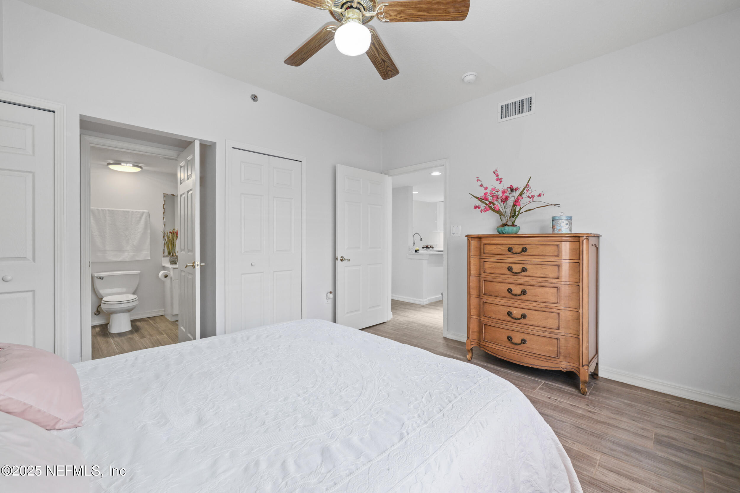 159 Marine Street, Unit 105 St. Augustine, FL 32084 - Photo 27 of 46 a bedroom with a dresser and a chandelier