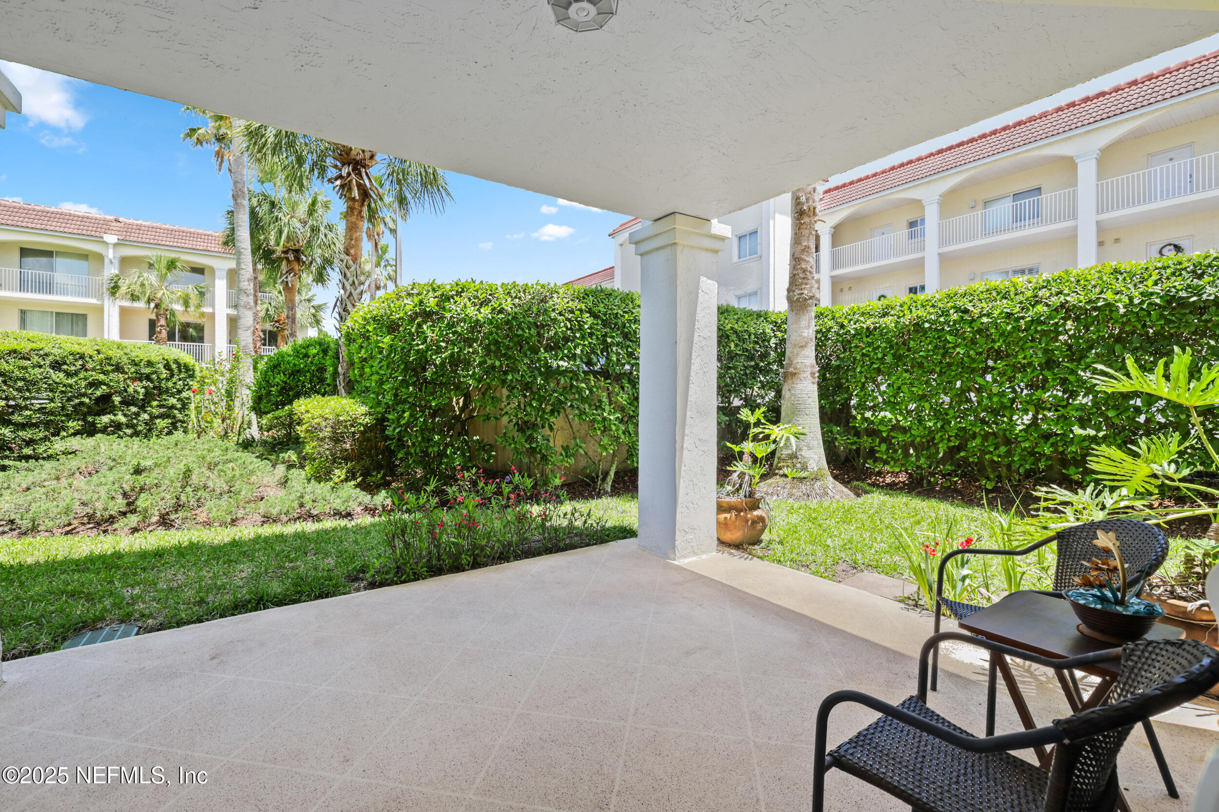 159 Marine Street, Unit 105 St. Augustine, FL 32084 - Photo 33 of 46 a view of a chair and table in front of a building