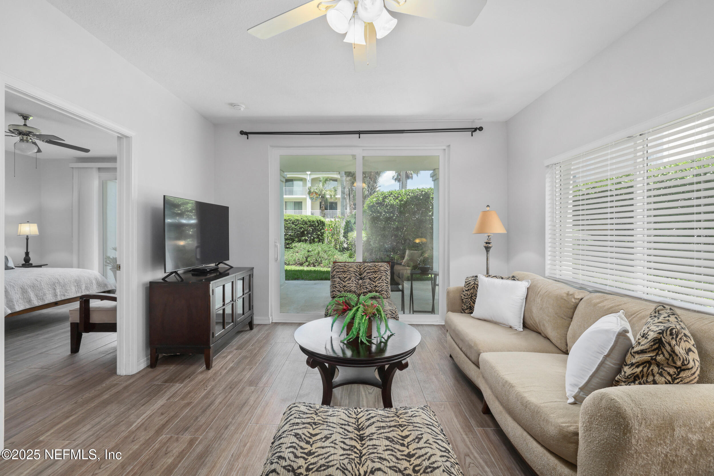159 Marine Street, Unit 105 St. Augustine, FL 32084 - Photo 4 of 46 a living room with furniture and a flat screen tv