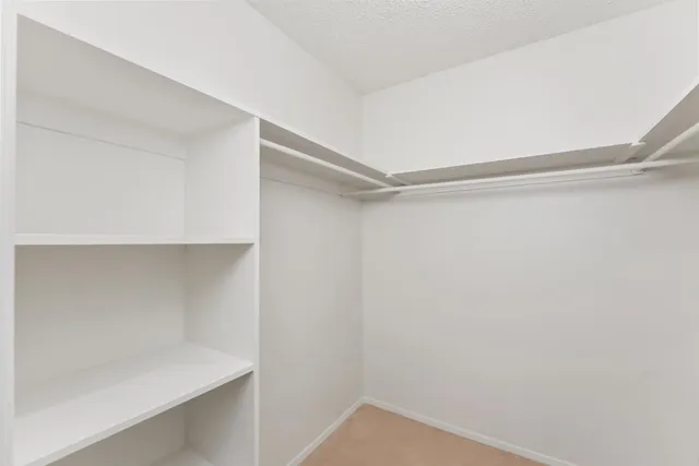 a view of an empty walk in closet