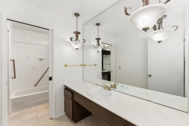 a bathroom with a sink a mirror and a shower