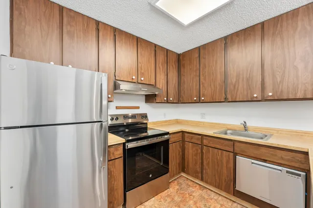 a white refrigerator freezer sitting inside of a kitchen